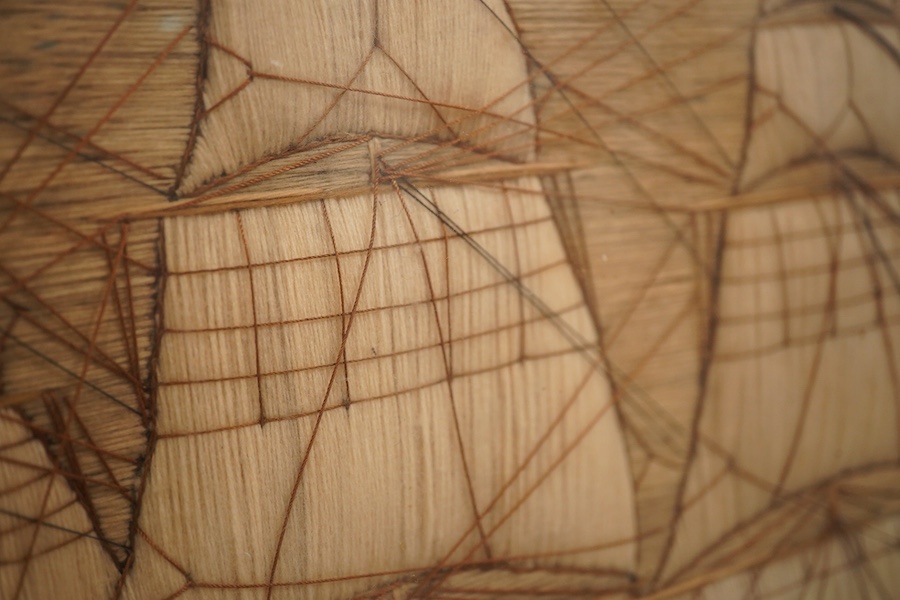 A maple framed 19th century ‘woolie’ folk art, wool work embroidery of a fully rigged sailing ship. Embroidered by a sailor using wading, creating raised stump work sails, using long straight stem stitches both verticall